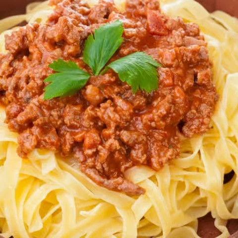 Fettuccine Bolognese with a sprig of parsley